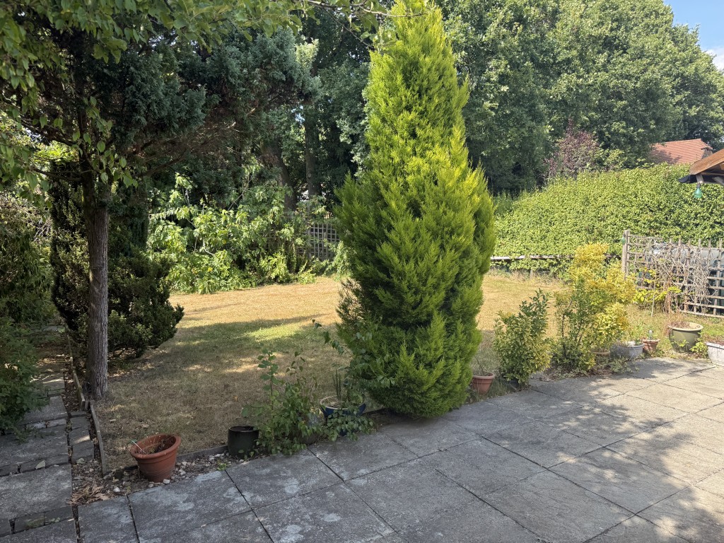 Lot: 122 - DETACHED BUNGALOW WITH ROOF CONVERSION AND POTENTIAL - Rear garden with patio area and oil tank